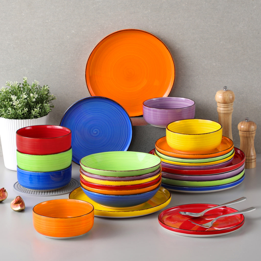 Casets Bonita 24-Piece Lipped-Edge Stoneware Dinnerware Set in Multicolor, Featuring a Vintage Spiral Pattern in Vibrant Hues.
