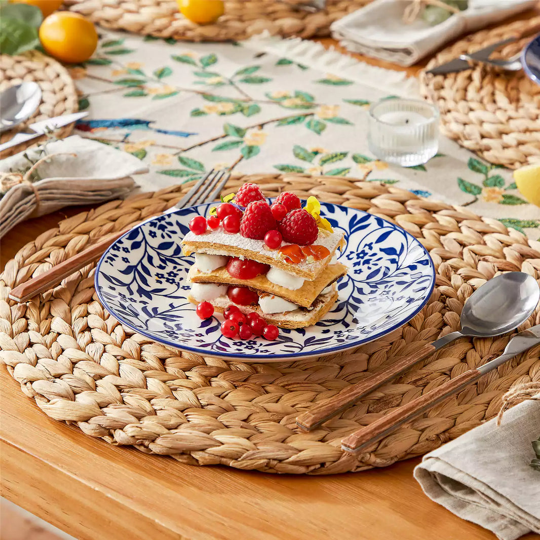 Selene porcelain dessert plate styled with raspberry honey cake on a woven rattan placemat, Japanese-inspired dinnerware set of 4.