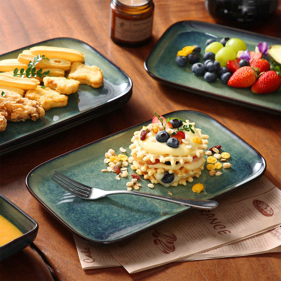 Green rectangular Stern serving platters, set of 4, filled with diverse appetizers, chicken nuggets, waffle with berries, and fries.